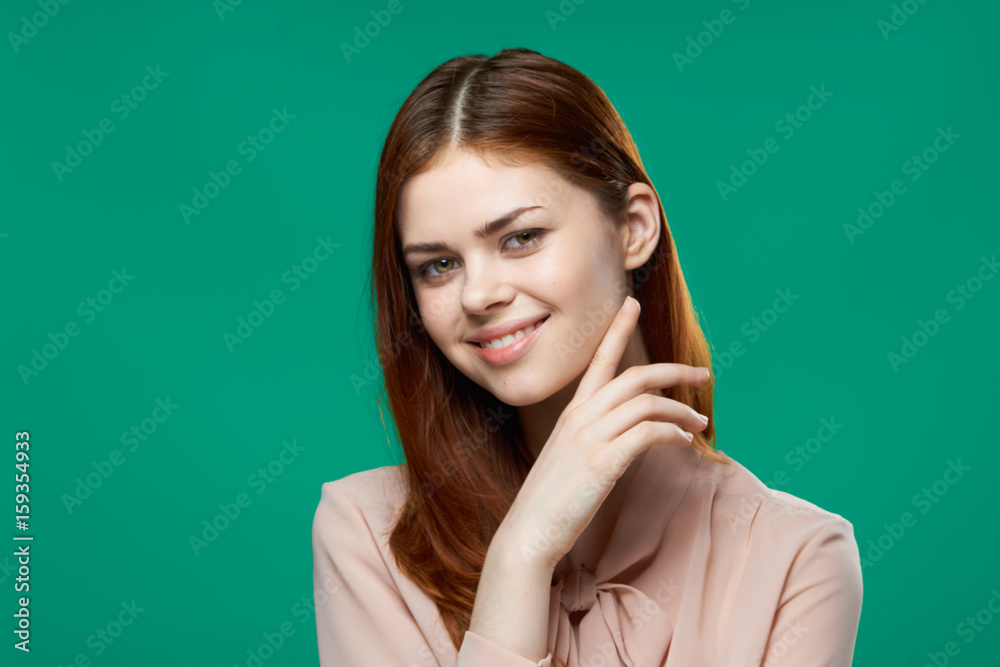 Woman with her hair down and smile on a green background Woman with her hair down and smile on a green background