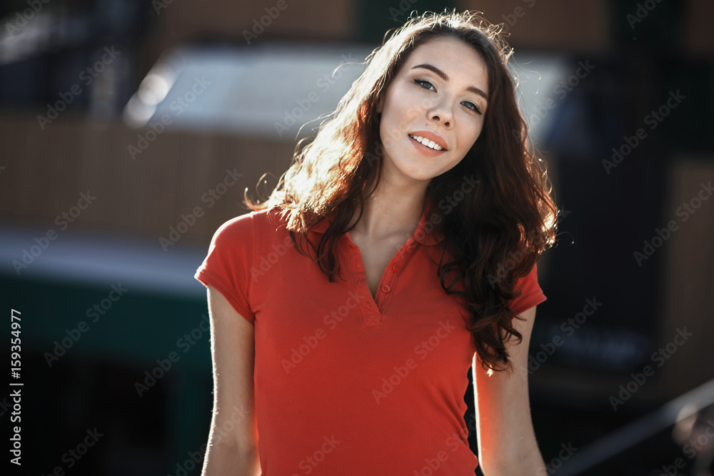 Summer sunny lifestyle fashion portrait of young woman posing in the city