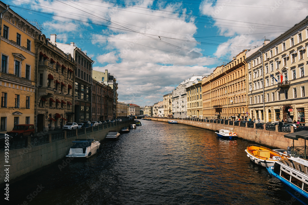 Embankment of the Moika River in sunny day, St. Petersburg, Russia, city canal with boats