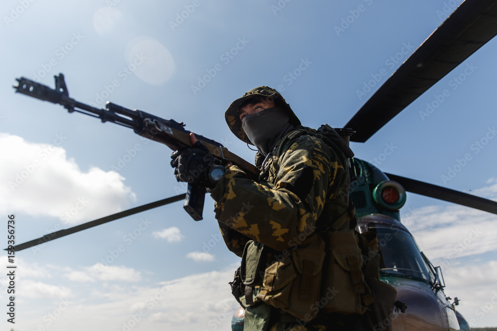 Photo of a soldier with an automatic rifle Photo of a soldier with an automatic rifle