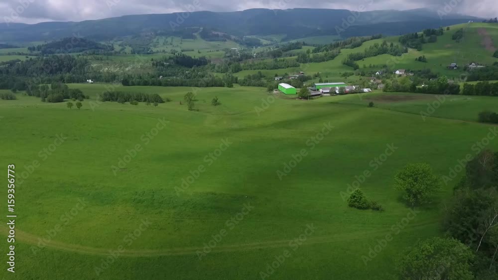 Aerial View. Panorama. Flight over a green grassy in mountains. Aerial View. Panorama. Flight over a green grassy in mountains.