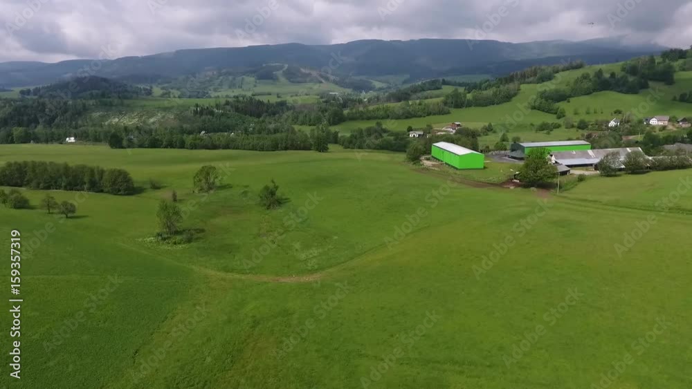 Aerial View. Panorama. Flight over a green grassy in mountains. Aerial View. Panorama. Flight over a green grassy in mountains.