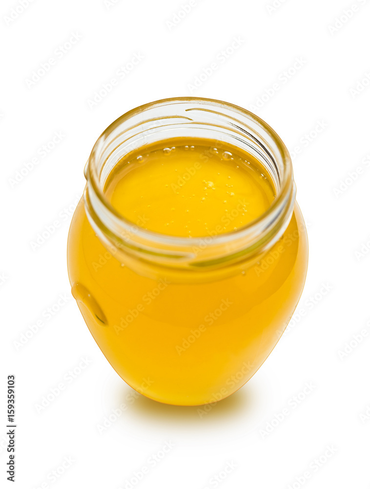 Sweet honey in glass jar on white background. Sweet honey in glass jar on white background.