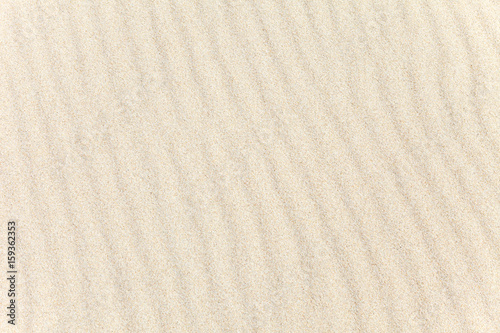 The wavy texture of the sand on the beach. The background image. Top view