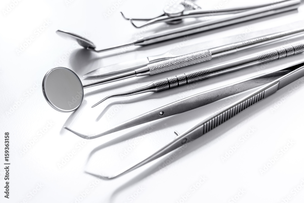 dentist tools close up on white hospital desk background dentist tools close up on white hospital desk background