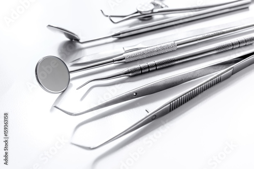 dentist tools close up on white hospital desk background