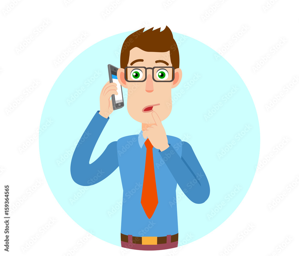 Businessman talking on mobile phone and standing with his finger to his lips