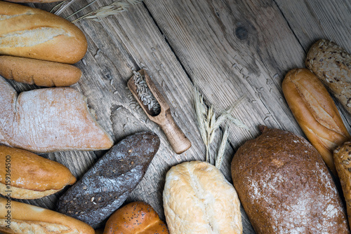 Assortment of baked bread on wooden rustic table background