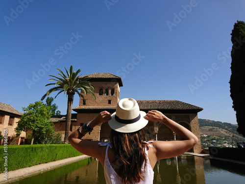 Woman gazing the Partal Palace on a sunny summer day, Alhambra, Granada photo