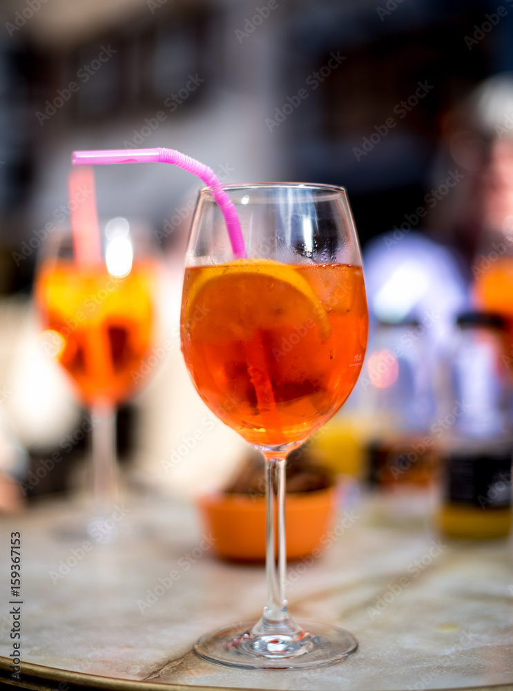 Naklejka premium Orange tincture apero, refreshing drink with ice and lemon