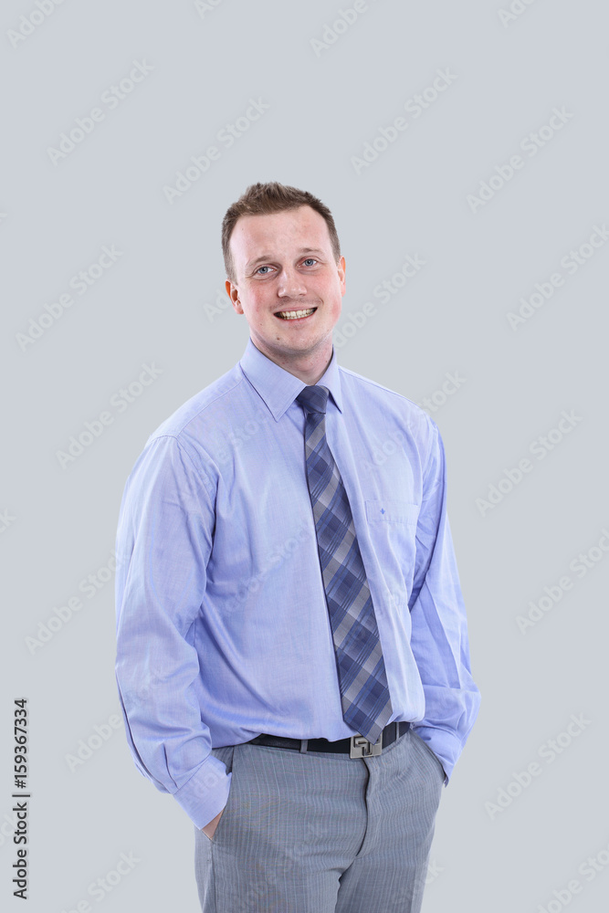 Young manager in suit is smiling isolated on gray background Young manager in suit is smiling isolated on gray background