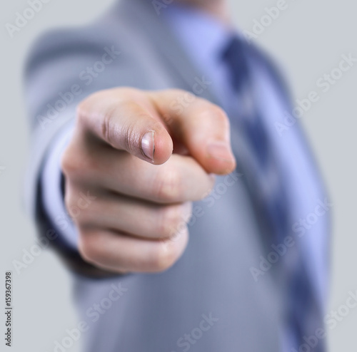 The body of a business man in a suit pointing with his finger