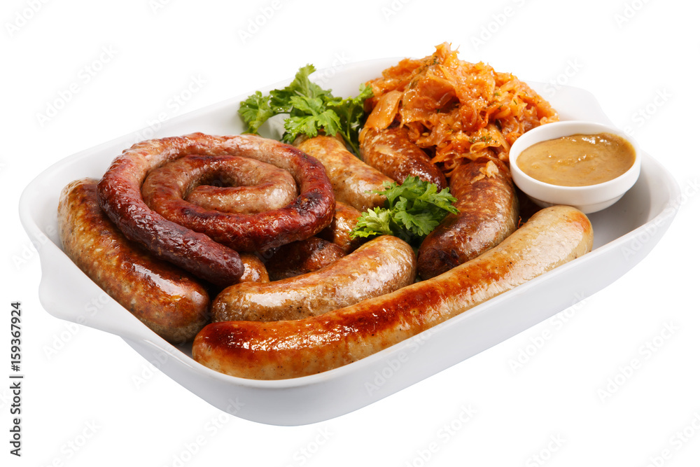 Sausage on a white plate with stewed cabbage and mustard Sausage on a white plate with stewed cabbage and mustard