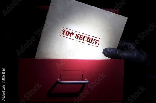 Looking for top secret documents in a dark. photo
