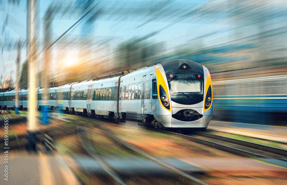 high-speed-train-in-motion-at-the-railway-station-at-sunset-modern