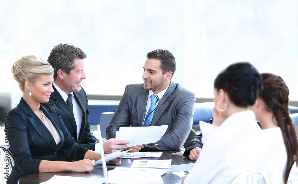 Business people working around table in modern office Business people working around table in modern office