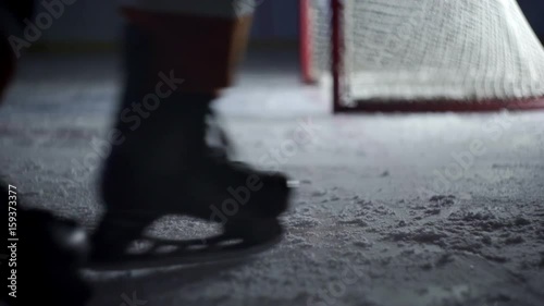 Hockey player on the ice slows sharply close-up of feet