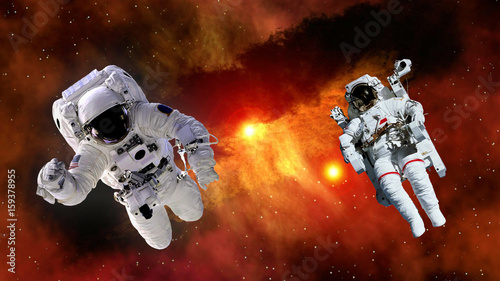 Two astronaut planet spaceman suit outer space gravity galaxy floating universe explosion. Elements of this image furnished by NASA.