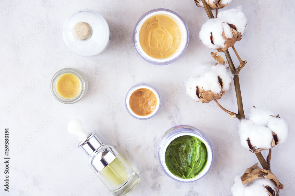 Natural skincare cosmetic products on white marble table from above. Creams, balms, masks, oils, serums. Beauty blogger concept Natural skincare cosmetic products on white marble table from above. Creams, balms, masks, oils, serums. Beauty blogger concept
