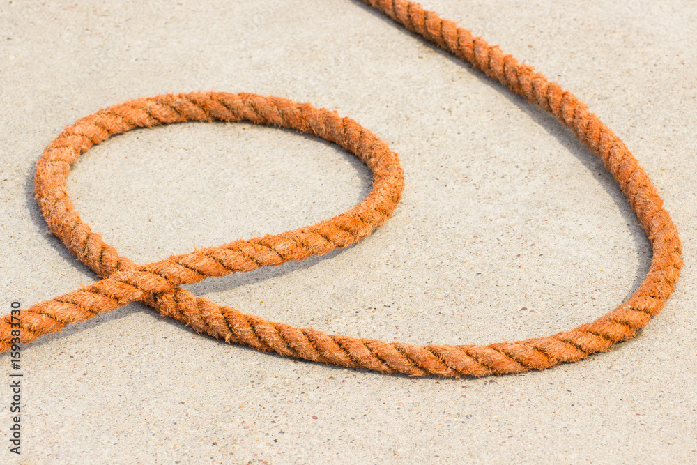 Orange rope on concrete in seaport