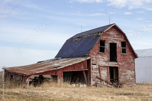 Old Red Barn. Abandoned early 1900's style wooden barn in the rural countryside of America's Midwest. © ehrlif