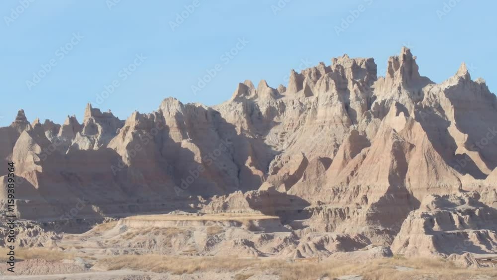 CLOSE UP: Steep pointy sandstone mountaintops against clear blue sky at Badlands National Park in South Dakota. Outer space landscape with eroded rocky mountain formations in Great Plains grassland CLOSE UP: Steep pointy sandstone mountaintops against clear blue sky at Badlands National Park in South Dakota. Outer space landscape with eroded rocky mountain formations in Great Plains grassland