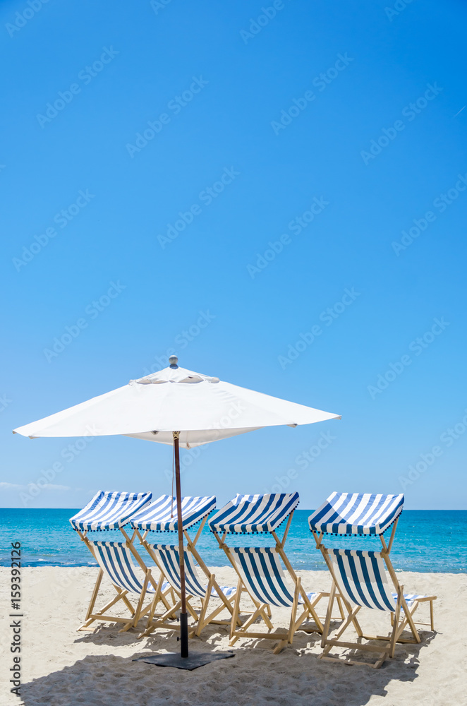 Beach chairs near the ocean background