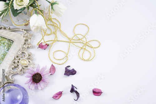 Perfume bottles with white rose flowers on light background. fragrance cosmetics, fragrance collection. Free space for text. Purple concept