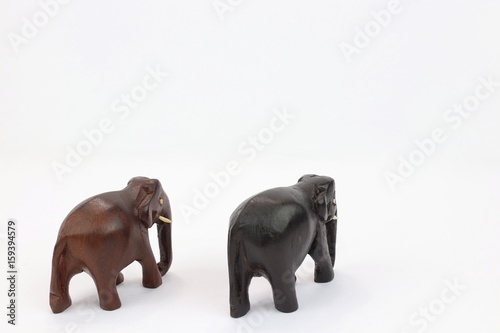 hand carved wooden elephants facing away isolated on white background  © RenysView