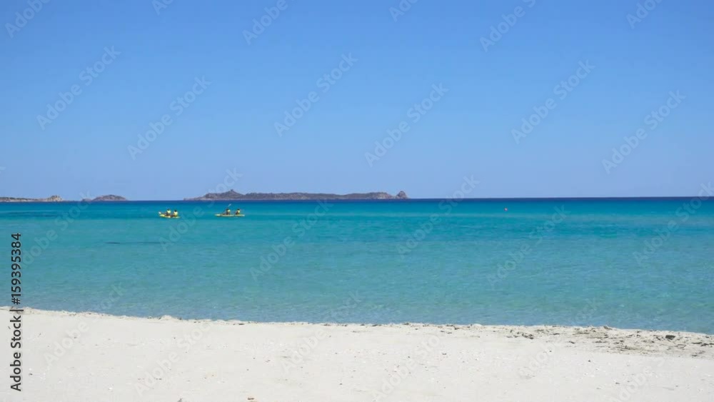 People Kayaking on a White Wild Mediterranean Sea Beach in Italy with Clear Blue Water People Kayaking on a White Wild Mediterranean Sea Beach in Italy with Clear Blue Water