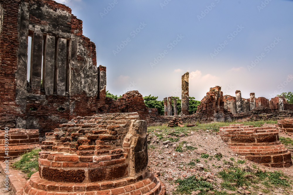 Wat Mahathat with Ruins of stupa and statue in the ancient Thai temple in Ayutthaya Historical Park.