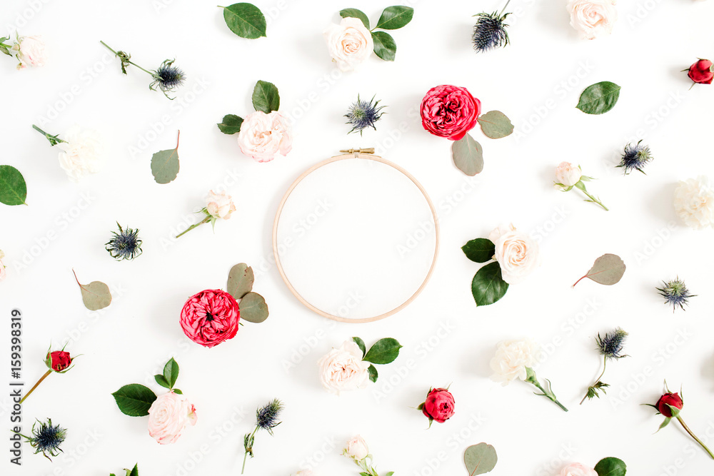 Embroidery frame with red and beige rose flower buds pattern on white background. Flat lay, top view decorated concept. Embroidery frame with red and beige rose flower buds pattern on white background. Flat lay, top view decorated concept.