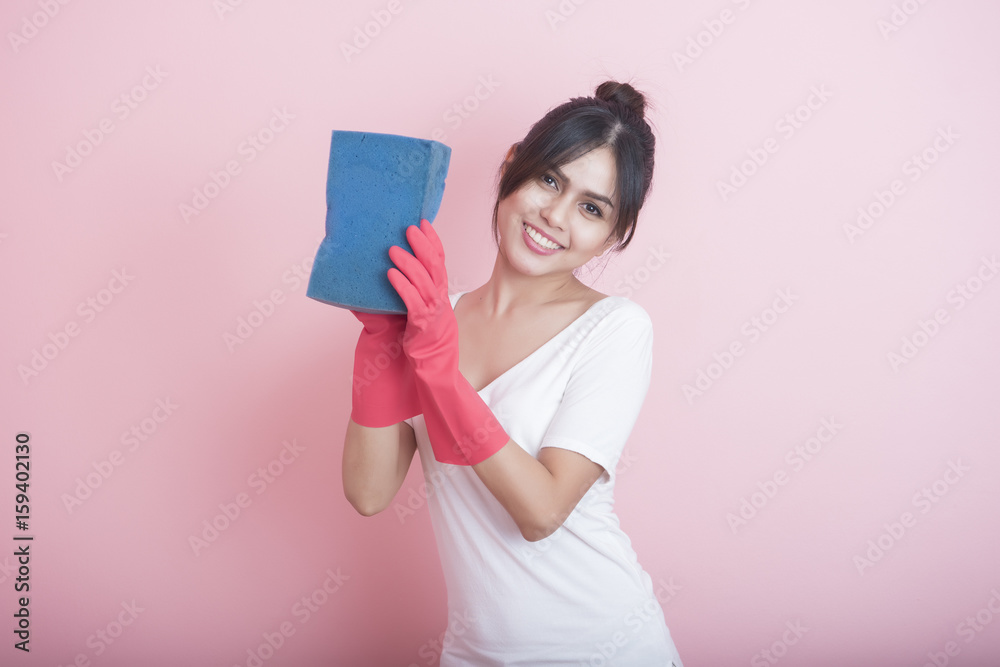 Beautiful asian housewife smiling on pink background Beautiful asian housewife smiling on pink background