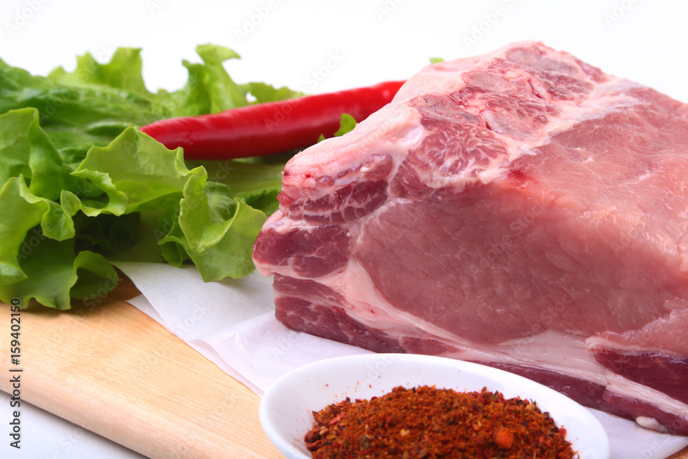 Raw pork chops with herbs and spices on cutting board. Ready for cooking.