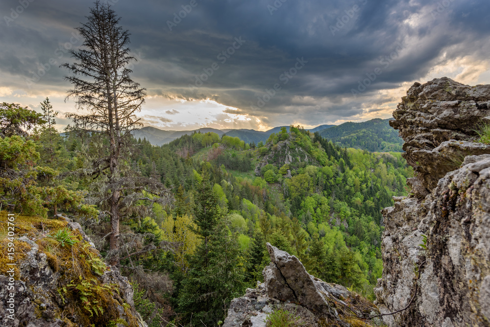 Sun through stormy clouds - beautiful, breathtaking sunset over the mystical Rhodope mountains in Bulgaria, Europe
