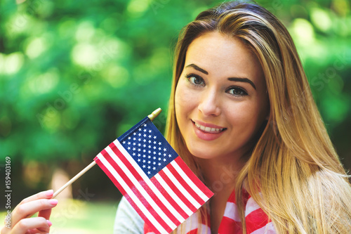 GIrl with an American flag on the fourth of July