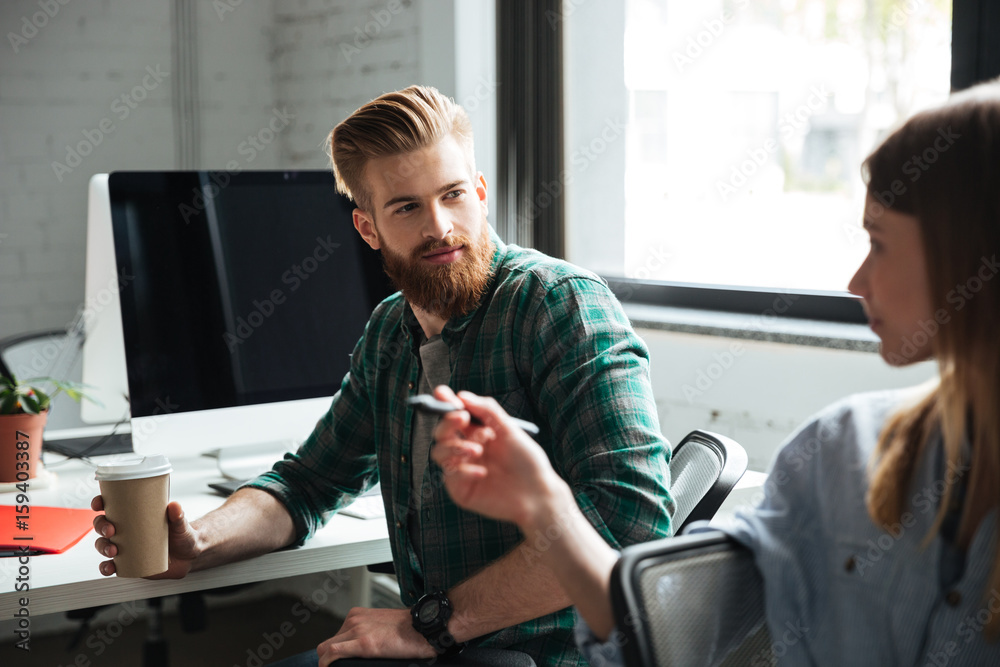 Two young concentrated colleagues work in office Two young concentrated colleagues work in office