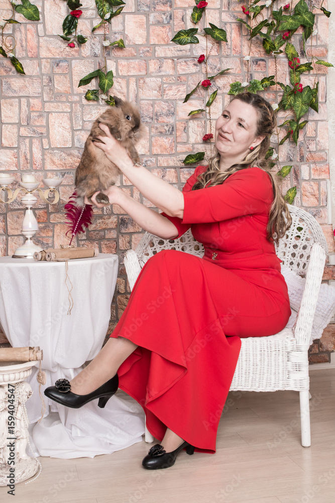 Ugly domineering woman is posing in red dress