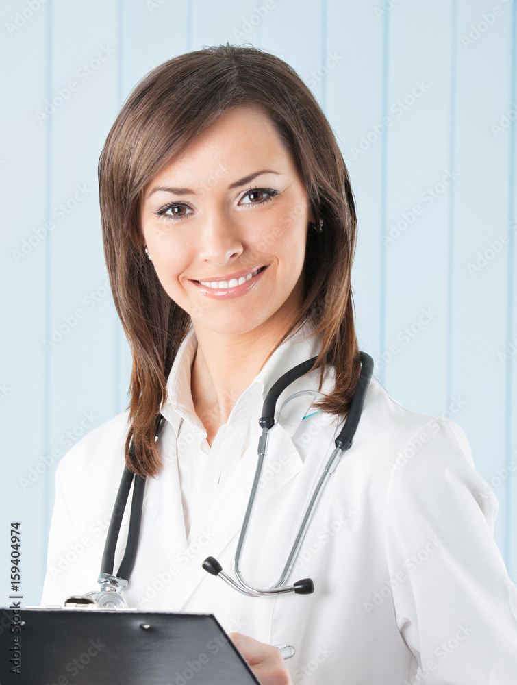 Smiling female doctor with clipboard at office Smiling female doctor with clipboard at office