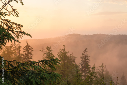 Mountain landscape in fog at sunset