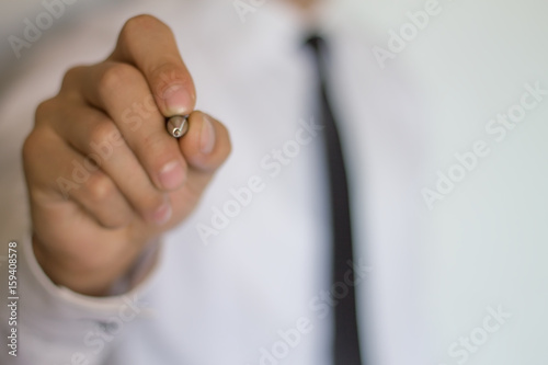 Businessman writing on a touch screen.