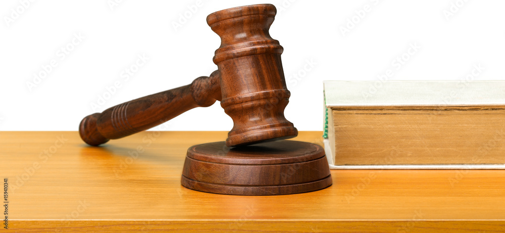 Wooden gavel and books on wooden table