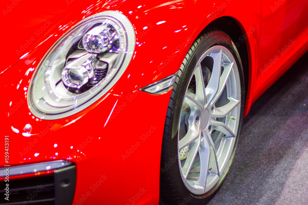 Closeup - front of red sport car and wheel style modern