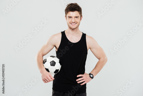 Happy young sportsman with foot ball