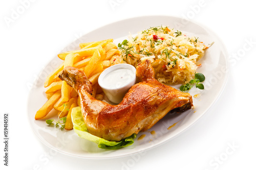 Roast chicken leg with french fries on white background