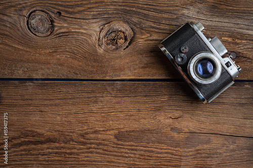 Vintage camera on wooden background.