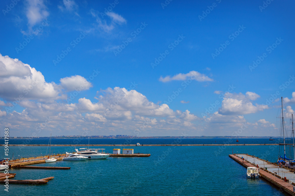 moored yachts on the background of blue sky