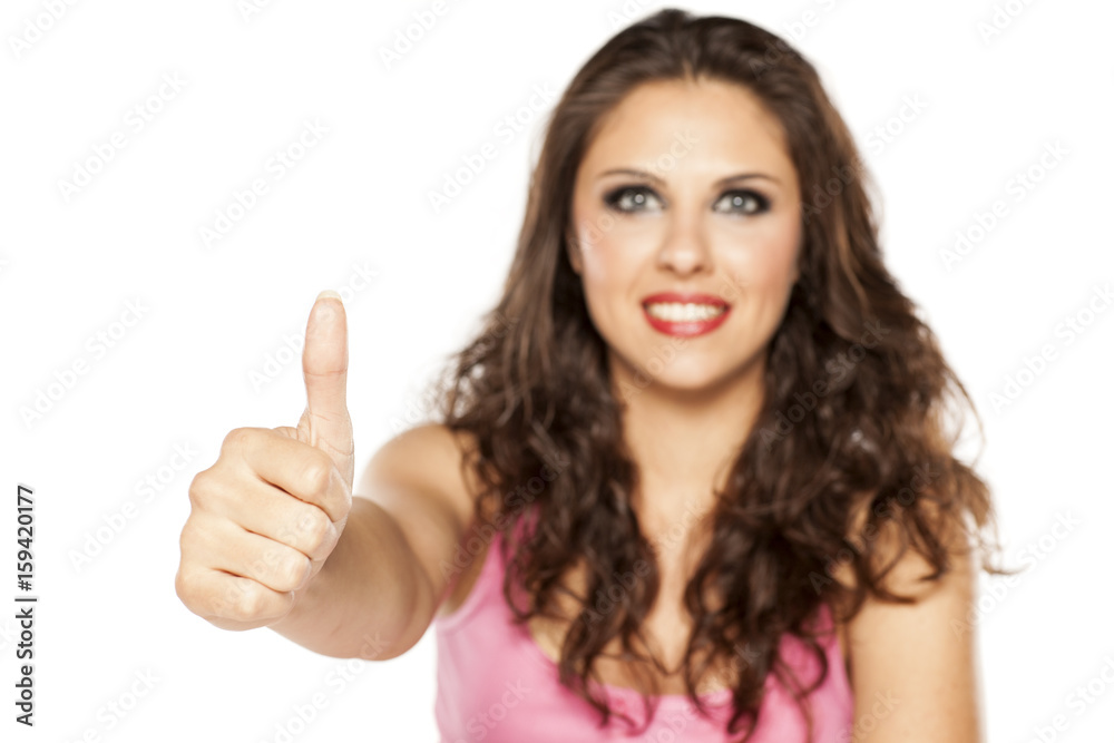 A young beautiful woman showing thumbs up A young beautiful woman showing thumbs up