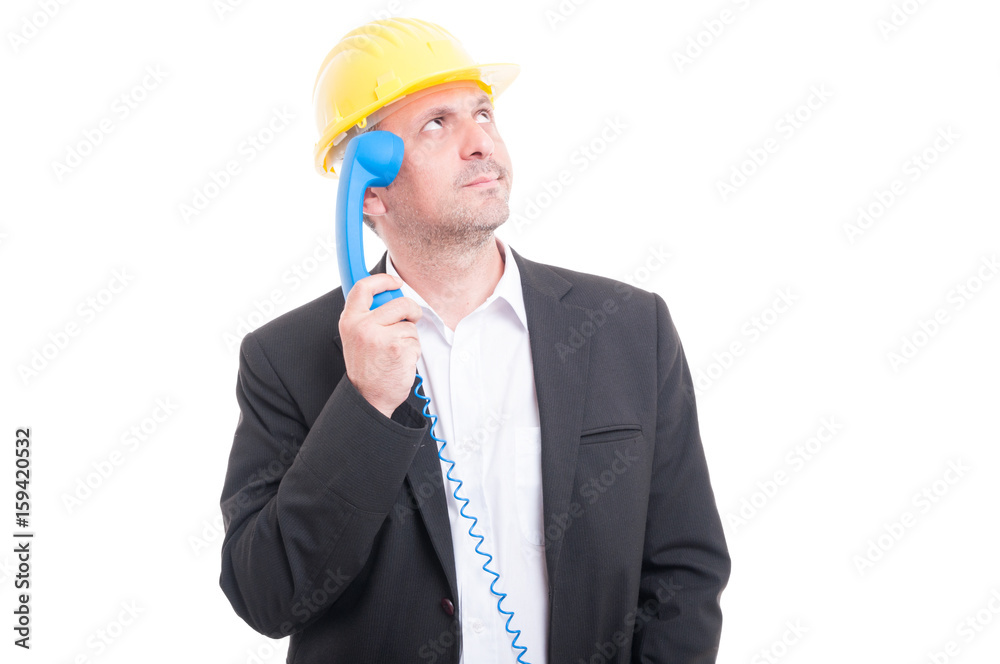 Portrait of architect wearing hardhat making thinking gesture Portrait of architect wearing hardhat making thinking gesture