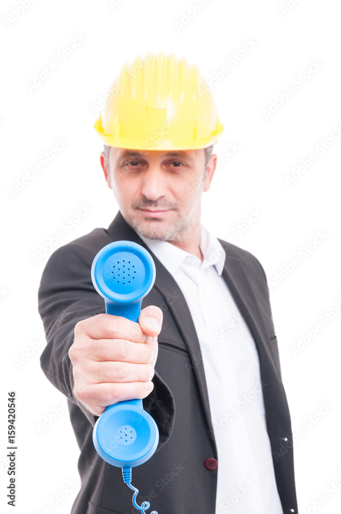 Selective focus of architect showing big blue telephone receiver Selective focus of architect showing big blue telephone receiver